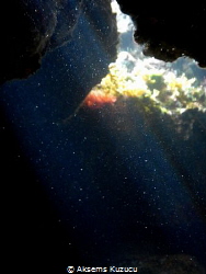 In a cave, under half daylight particals glare like stars... by Aksems Kuzucu 